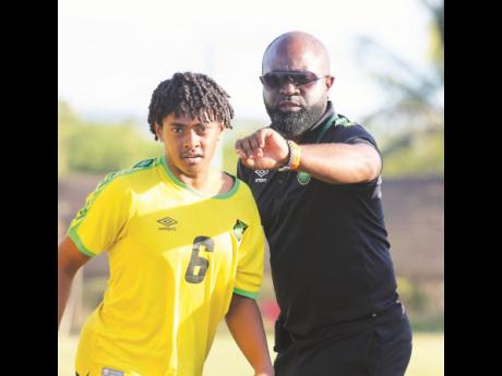 Credit: Lennox Aldred
Jamaica under-17 coach Merron Gordon (right) instructs midfield substitute Jordan Mangatal before he enters the field of play against Vere United in a paractice match at the Wembley Centre of Excellence recently.