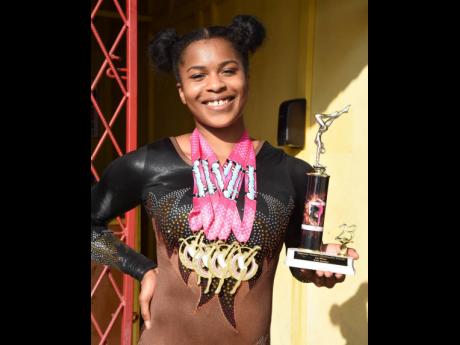 Credit: Ian Allen
Tyesha Mattis shows off the medals she won during the Gymnastics Classics and National Trial at the Gymnastic Training Centre in Kingston on Saturday.