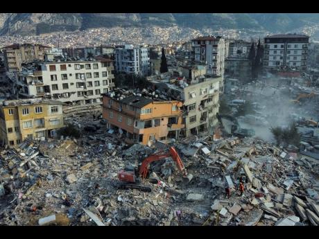 An aerial view of collapsed buildings in Antakya, southeastern Turkey, Saturday, February 11, 2023. Rescue teams using thermal cameras to locate signs of life are continuing to pull survivors out of mounds of rubble, five days after a major earthquake stru
