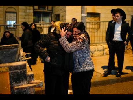 The women mourn during the funeral of eight-year-old child Asher Menahem Paley after he died of injuries suffered a day before in a car-ramming attack by a Palestinian man.