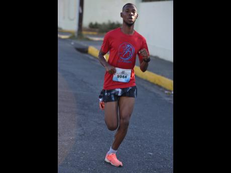 Garfield Gordon charging to victory in the Sagicor Sigma 25th Legacy Run in New Kingston Sunday.