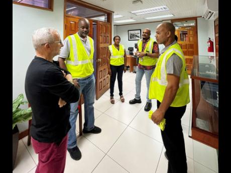 Credit: Contributed KFTL CEO Capt Jedrzej Mierzewski (left), along with members of the Human Resources and Industrial Relations team, share encouraging words with Anthony Davis (second left) and Kaneil McKenzie (right) ahead of their departure to Nigeria.