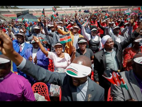 Kenyans attend a national day of prayer held at Nyayo Stadium in the capital Nairobi, Kenya, yesterday. 