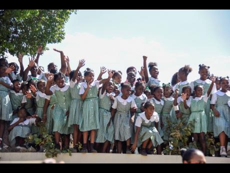 St George’s Girls Primary and Infant School students watch with excitement the ceremonial opening of Parliament from an elevated spot on Duke Street.