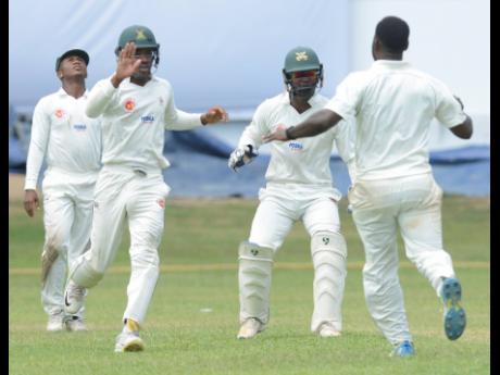 Members of the Melbourne Cricket Club team celebrate the dismissal of a Jamaica Defence Force batsman during the Jamaica Cricket Association Senior Cup final at Sabina Park on Saturday, April 13, 2019. File