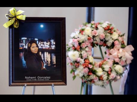 A picture is displayed during a memorial service for Nohemi Gonzalez.