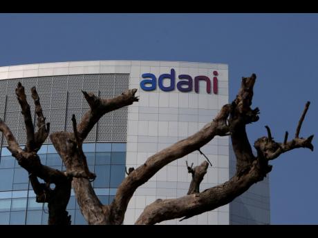 Dried branches of a tree stand outside Adani Corporate House in Ahmedabad, India, on Friday on January 27.