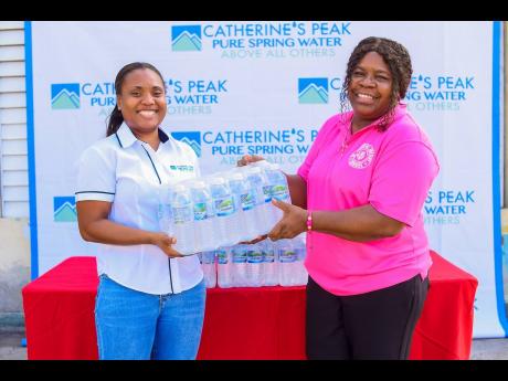 Kadia Harris (left), Grace Foods brand manager, Catherine’s Peak, presents a case of bottled water to Rose Marie Clarke, principal of St Joseph’s Infant School. Catherine’s Peak, a subsidiary of Grace Foods Division, a part of the GraceKennedy Group,