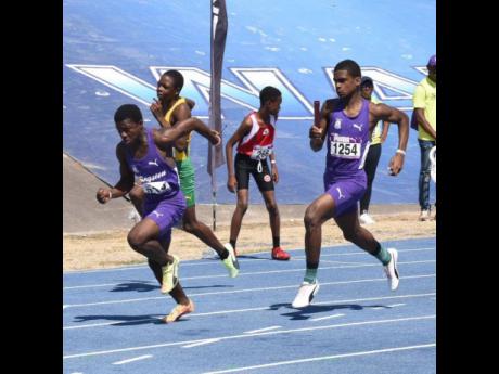 Kingston College's Class Three unit goes through a baton change during the Boys' 4x100 heats at the Gibson McCook Relays inside the National Stadium earlier today.