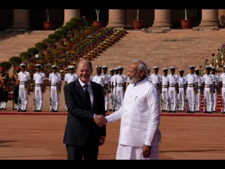 Indian Prime Minister Narendra Modi (right) welcomes German Chancellor Olaf Scholz during a ceremonial reception at the presidential palace in New Delhi, India.