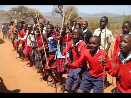 Maasai children line up to greet US First Lady Jill Biden and US Ambassador to Kenya Meg Whitman during their visit to Ngatataek, Kajiado Central, Kenya.