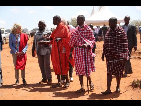 US First Lady Jill Biden, left, greets members of the Maasai community as they explain the drought situation in Ngatataek, Kajiado Central, Kenya.