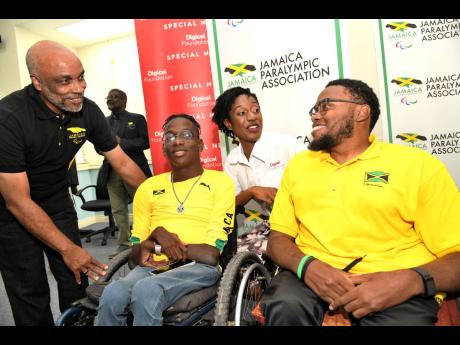 Christopher Samuda, Jamaica Paralympic Association president and president of  Jamaica Olympic Association (left), and Jodi-Ann McFarlane, senior operations manager of Digicel Foundation (second right), chat with Paralympic athletes Nathaniel Bailey (secon