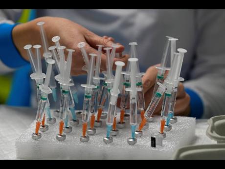 A nurse prepares vaccines in the Wizink Center, used for COVID-19 vaccinations in Madrid, in 2021. 