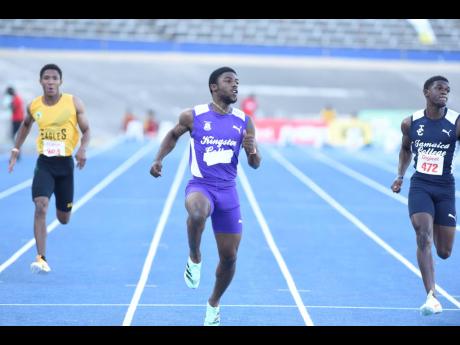 Credit: Nicholas Nunes Kingston College’s (KC) Bouwahjgie Nkrumie (centre) checks his time after winning the Class I boys’ 100 metres at the Anthrick Corporate Area Athletics Championships at the National Stadium today. Nkrumie clocked 10.32 seconds to win ahead of Jamaica C