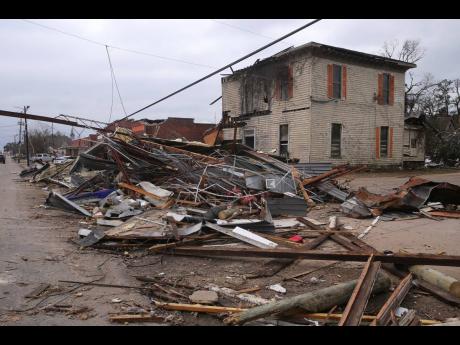Debris from local businesses covers the street in Selma, Alabama, on January 13, after a tornado passed through the area. 
