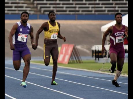 Credit: Ian Allen Kingston College's Bouwahjgie Nkrumie (left) strides to an easy victory over DeAndre Daley (right) of Herbert Morrison in the Under-20 boys' 100 metres final at the Carifta Trials at the National Stadium today. Nkrumie clocked 10.18 seconds, with Daley doi