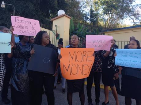 Teachers at the Manchester High School protesting on Tuesday as they object to the latest offer under the compensation restructure scheme by the Government.