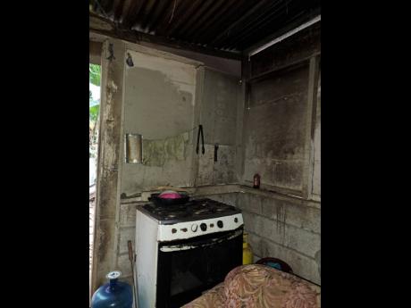 Credit: Photo by Tanesha Mundle A stove sits in a corner of the cramped one-bedroom house in which Shanakay Williams lives with her two children in Golden Spring, St Andrew.