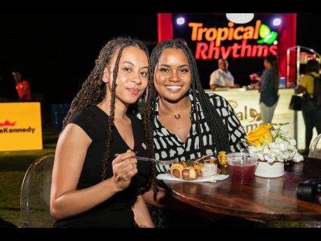 Nyoka Whyne (left) and Ashli-Raye Recas pause from enjoying their bites of food to smile for our camera. 