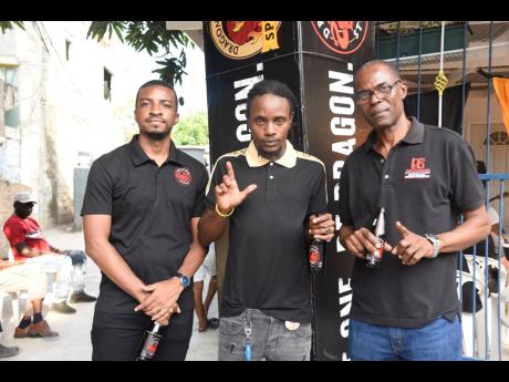 From left: Arnaldo Martin, junior brand manager, Dragon; recoding artiste Nation Boss, and Dennis Beckford.