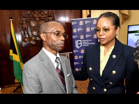 Rocky Meade from the Office of the Prime Minister with Marlene Malahoo Forte, minister of legal and constitutional affairs, co-chairs of the Constitutional Reform Committee.