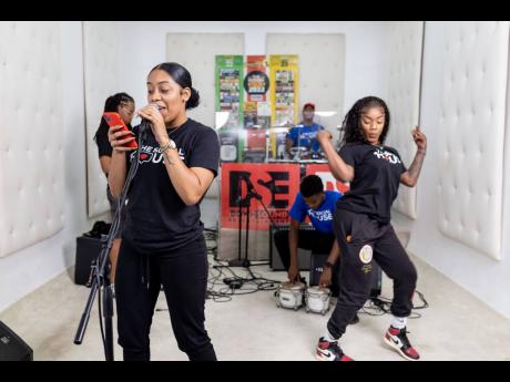 Digital content creator and influencer Lee Not Nice performs her winning freestyle as fellow cast member, recording artiste Rebel dances in the background. 