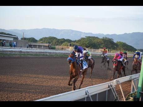 BRINKS (left), ridden by Omar Walker, wins the Pick 3 Super Challenge Trophy, a Restricted Allowance Stakes for two-year-olds over seven furlongs at Caymanas Park, on  Saturday, November 27, 2021.