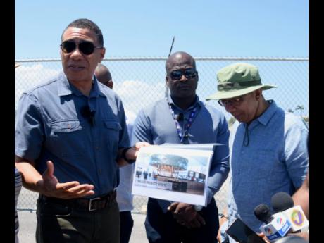 Prime Minister Andrew Holness (left) discusses expansion plan for the ongoing runway extension and civil infrastructure project at the Sangster International Airport in Montego Bay, St James. With him are Shane Munroe, CEO MBJ Airports (centre), and Horace