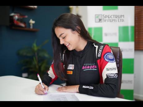 Contributed 
Formula Woman driver Sara Misir signs a contract officially recognising the partnership between herself and Spectrum Systems for the 2023 Jamaican motorsports season.