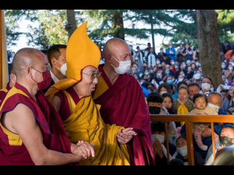 Tibetan spiritual leader the Dalai Lama, in a ceremonial yellow hat, arrives at the Tsuglakhang temple to give a sermon in Dharamsala, India, on March 7.