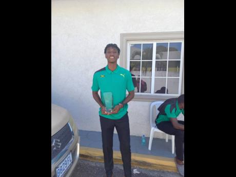 Roshawn Clarke poses with his Austin Sealy Award replica at the Jamaica Athletics Administrative Association office yesterday.