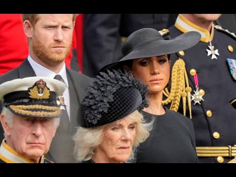 FILE - Britain’s King Charles III, from bottom left, Camilla, the Queen Consort, Prince Harry and Meghan, Duchess of Sussex, attend the state funeral service of Queen Elizabeth II in Westminster Abbey, London, Monday Sept 19, 2022. Buckingham Palace says