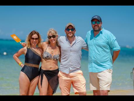 Visiting Jamaica from Wales (from left) Donna Stevens, Natalie Adams, Tim Adams and Elliot Stevens shared a moment along the shores of Pearly Beach in Ocho Rios during the Frenchmen Rise Up day party on Saturday. 