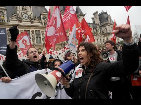 Demonstrators gather outside the Paris town hall, Friday, April 14, 2023 in Paris. 