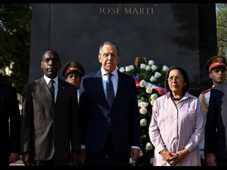 Russia’s Foreign Minister Sergey Lavrov (centre) poses for a photo during a wreath-laying ceremony at the José Martí Monument in Havana, Cuba, yesterday. At left is Cuban deputy director general of the Department of Bilateral Affairs of the Cuban Forei