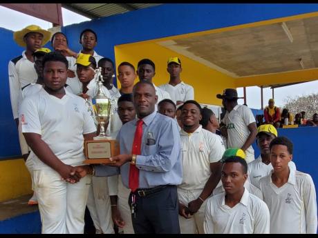 Credit: Photo by Kavarly Arnold Headley Cup chairman George Henry (centre) presents the ISSA Spalding Cup to St Elizabeth Technical High (STETHS) captain Maliek Williams after they claimed first innings honours in a rain-affected drawn playoff match against Wolmer’s Boys at the STET