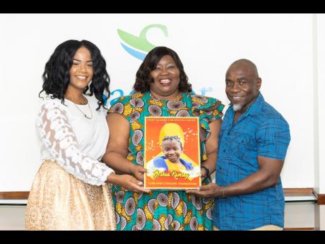From left: Sagicor Life Financial Advisor Rasheeba Edwards joins Corretta Foster, vice president – Group Human Resources, Sagicor Group Jamaica, and Kenroy Ramsay, co-founder of the Joshua Ramsay Cure and Conquer Foundation, in holding a picture of Joshu