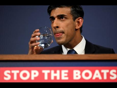 FILE – Britain’s Prime Minister Rishi Sunak prepares to take a sip of water during a press conference following the launch of new legislation on migrant channel crossings, at Downing Street, London, Tuesday, March 7, 2023. 