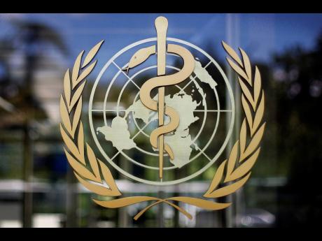 FILE - The logo of the World Health Organization at the WHO headquarters in Geneva, Switzerland, on June 11, 2009. The World Health Organization says it has fired one of its doctors who faced allegations that he had repeatedly engaged in sexual misconduct.