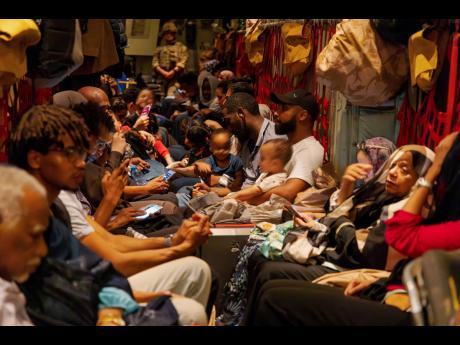 In this image, provided by the UK Ministry of Defence, on Wednesday, April 26, 2023, British nationals seen here onboard an RAF aircraft in Akrotiri, Cyprus, after being evacuated from Sudan. On planes and warships, world powers evacuated more people from 
