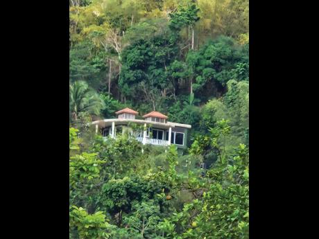 House in the mountains shielded by forestry.