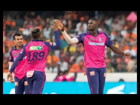 West Indies teammates Shimron Hetmyer (centre) and Jason Holder (right). 