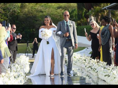 Credit: Ashley Anguin The bride is escorted up the aisle by her father, author Brian Samuel.