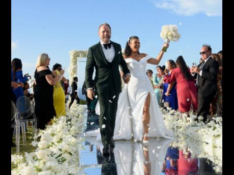 Credit: Ashley Anguin The lovely couple take their first walk as husband and wife down the aisle.