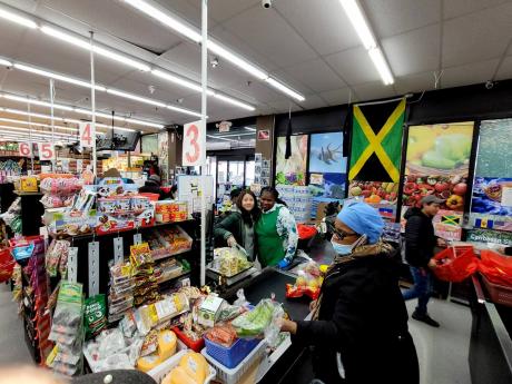 Joanna Chung and a Jamaican cashier inside SY Grace. 