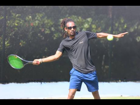 Top seed Damion Johnson about to hit a winner against Mackaiba Thomas yesterday in their opening round contest at the Bounty Invitational Tennis Classic being held at Couples Tower Isle. 