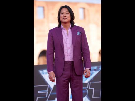 Actor Sung Kang, who reprises his role as Han Lue, poses for photographers. 