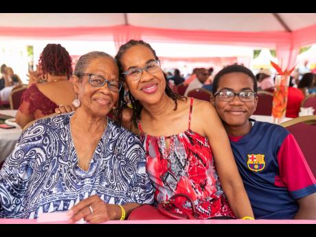  Justin Elliot (right) is out with two generations of moms, so he gets double the love. He embraces his mom, Nicola Elliot, and his grand-aunt, Dr Shirley Thomas.