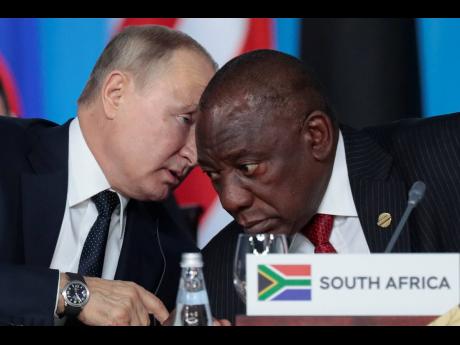 Russian President Vladimir Putin (left) speaks to South African President Cyril Ramaphosa, during a plenary session at the Russia-Africa summit in the Black Sea resort of Sochi, Russia, in 2019. 